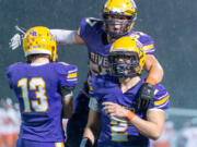 Columbia River's Diego Carrion jumps on the back of Adam Huerena, who recovered a second-half fumble, in a 2A Greater St. Helens League football game on Thursday, Oct. 21, at Kiggins Bowl. Columbia River won 16-13.