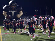 Camas High School football players run onto the field Friday, Oct. 22, 2021, before a game between the Papermakers and Skyview at Camas High School.