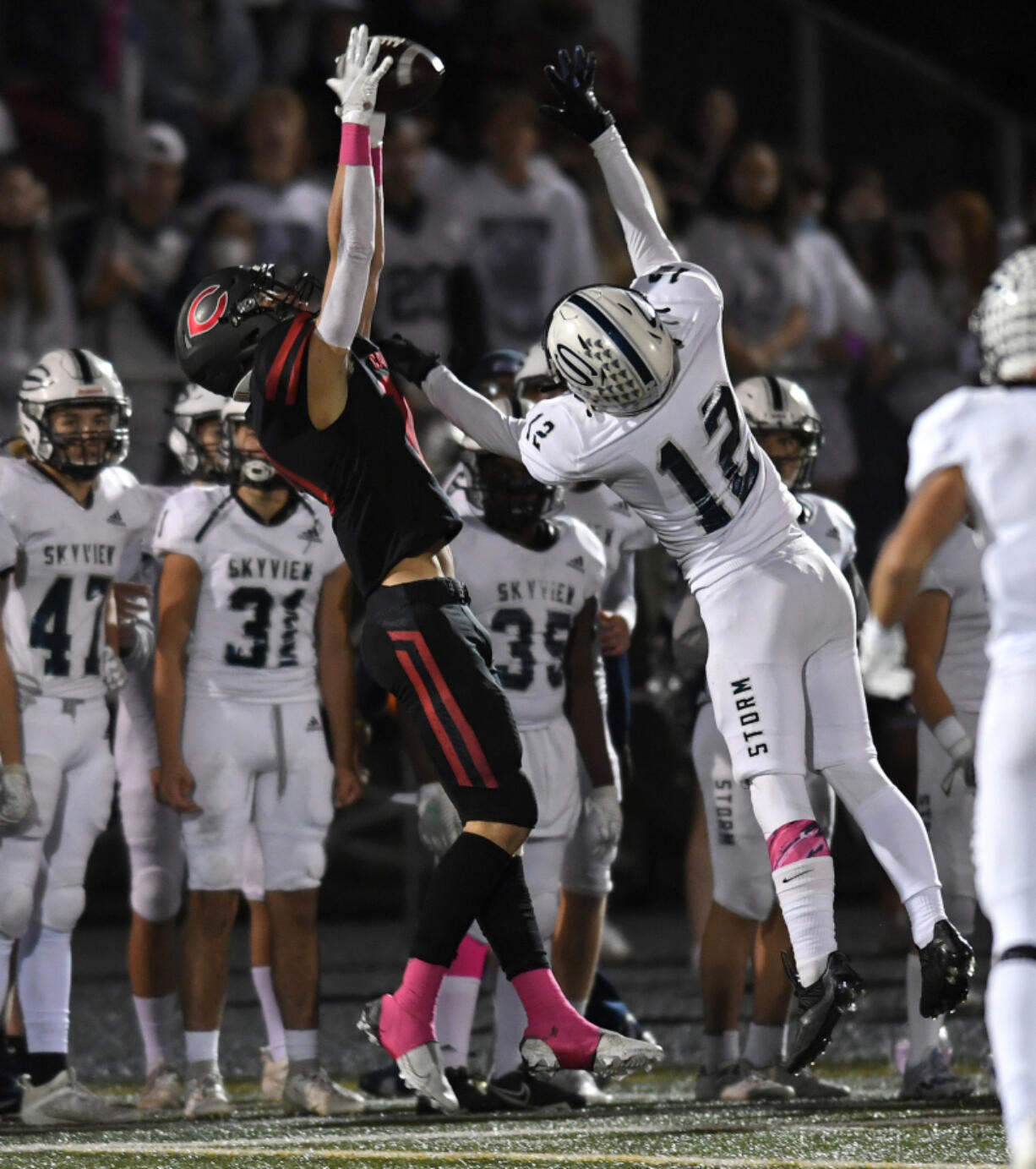 Camas senior Nathan Criddle, left, makes a leaping reception under pressure from Skyview sophomore Jerrid Secor on Friday during the Papermakers' 17-7 win against Skyview at Doc Harris Stadium.