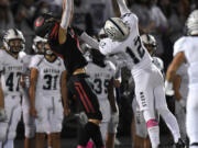 Camas senior Nathan Criddle, left, makes a leaping reception under pressure from Skyview sophomore Jerrid Secor on Friday during the Papermakers' 17-7 win against Skyview at Doc Harris Stadium.