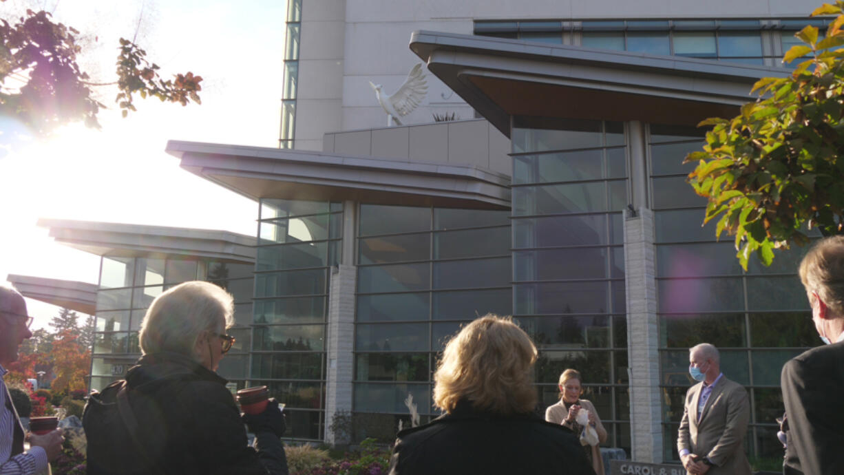 Community members gather for the unveiling of a new statue of a dove at PeaceHealth Southwest Medical Center's Firstenburg Tower.