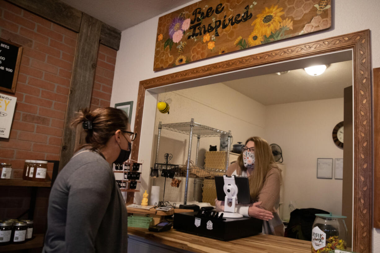 Joy Bochsler chats with a customer Monday at Joyful Honey and Beekeeping Supplies, 713 W. Main St., 102 in Battle Ground.