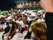 Camas players celebrate Friday, Oct. 29, 2021, following the Papermakers’ 17-7 win against Union at McKenzie Stadium in Vancouver.