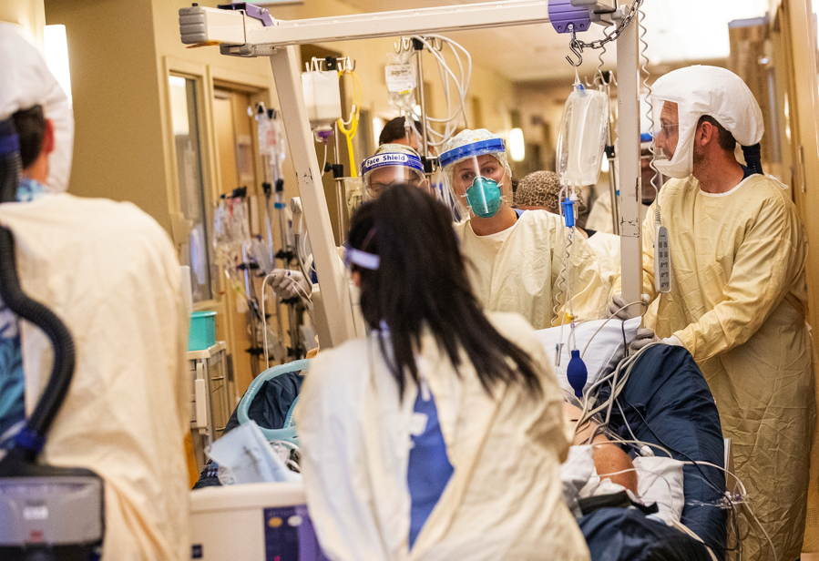 A medical team moves a COVID-19 patient to a new room in the ICU at Central Washington Hospital on Tuesday, Sept. 21, 2021.