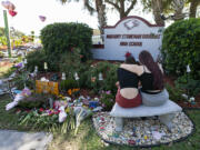 Mourners visit a makeshift memorial outside of Marjory Stoneman Douglas High School in Parkland, Florida, on Feb. 14, 2020, the two-year anniversary of the Parkland shooting that left 17 people dead. The shooting prompted Florida and other states to pass so-called red flag laws. (Matias J.