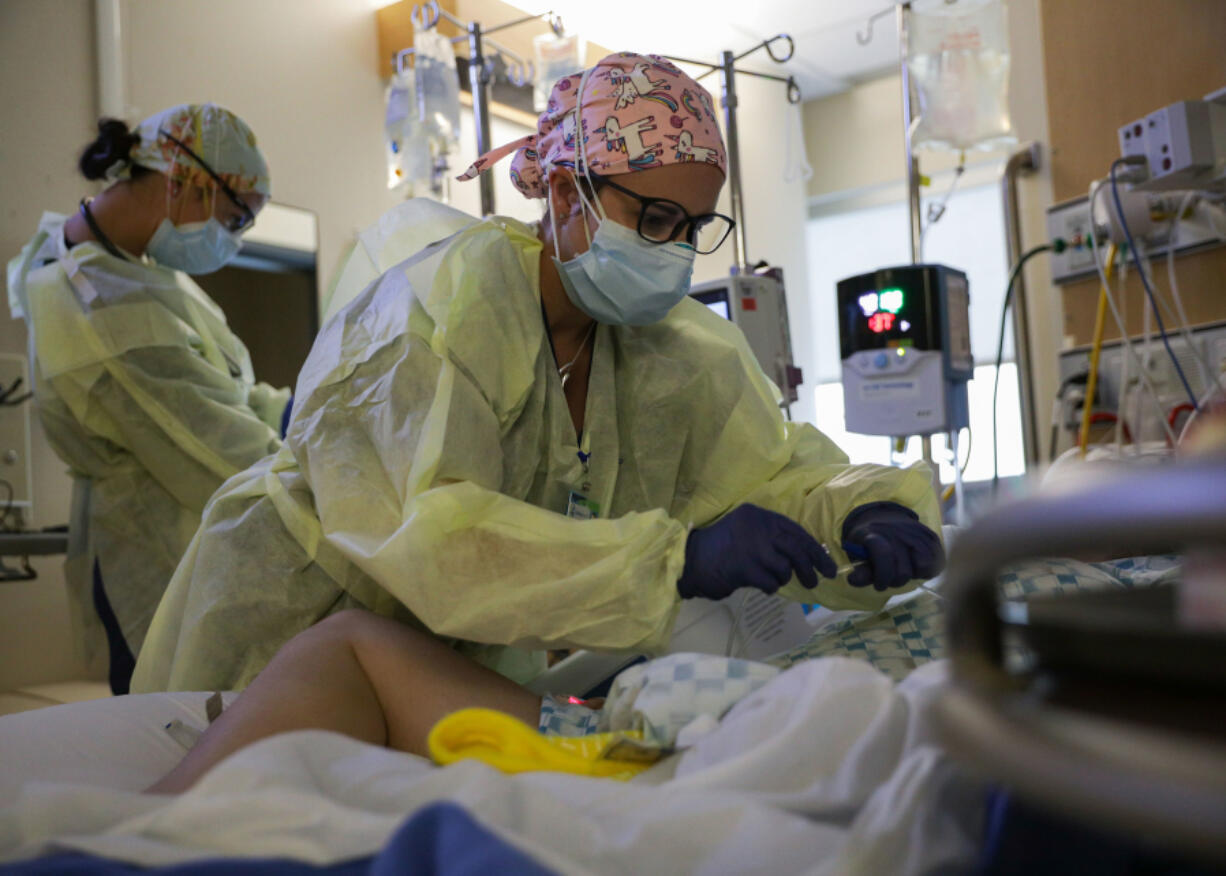 U.S. Army Capt. Corrine Brown, a critical care nurse, administers an anti-viral medication to a COVID-positive patient at Kootenai Health regional medical center Sept. 6 in Coeur d'Alene, Idaho. (Mass Communication Specialist 2nd Class Michael H. Lehman/U.S.