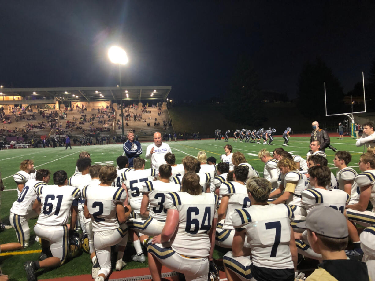 Kelso football coach Steve Amrine addresses his team following a 42-10 win over Evergreen on Friday at McKenzie Stadium.