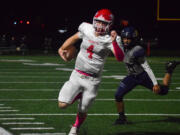 Castle Rock's Chance Naugle runs to the sideline to avoid a tackle from Seton Catholic's Amann Au (46) on Friday.