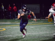 Seton Catholic's Joe Callerame (1) runs past Castle Rock's Landon Gardner (22) on Friday in Vancouver.