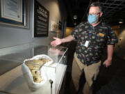 Jeff Stanford at an exhibit of coprolite (fossilized dinosaur droppings) at the Orlando Science Center on Oct. 12, 2021. The center currently has on display more than a dozen poop specimens, including the Guinness World Record holder of the largest fossilized excrement from a carnivore ever found. Just one example of unusual items that have insurance policies to protect them. (Stephen M.