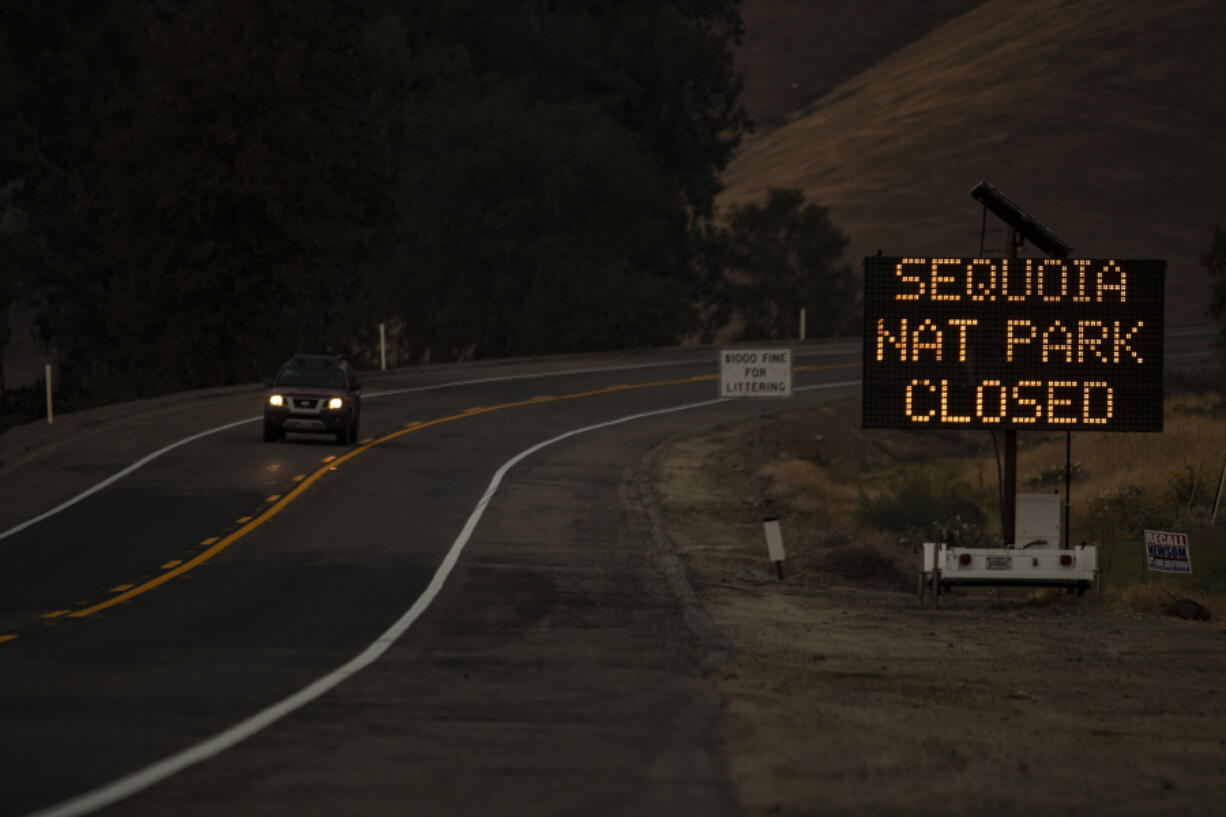 A sign warns motorists of the closure of Sequoia National Park as the KNP Complex fire threatens the area on Sept. 15, 2021 in Three Rivers, California.