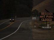 A sign warns motorists of the closure of Sequoia National Park as the KNP Complex fire threatens the area on Sept. 15, 2021 in Three Rivers, California.