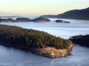 Steve Ringman/The Seattle Times 
  
 The lighthouse on the northern tip of Patos Island, with Sucia Island and Orcas Island in the distance, looks toward Canada across The Salish Sea.