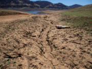 Dried mud and a stranded buoy on the lakebed at Lake Oroville, which stands at 33 percent full and 40 percent of historical average when this photograph was taken, on Tuesday, June 29, 2021 in Oroville, California.