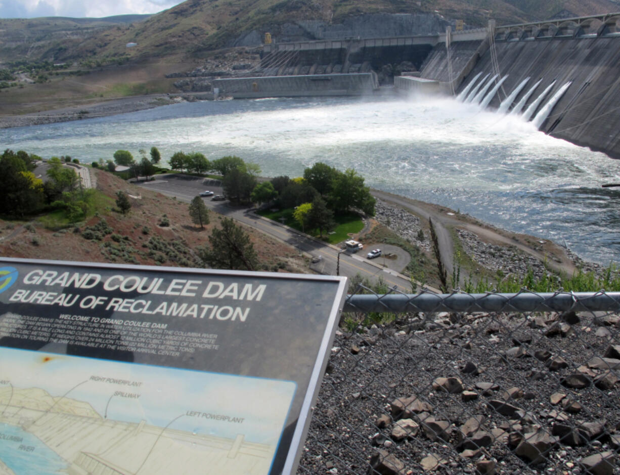 FILE - In this June 1, 2011 file photo, water is seen being released through the outlet tubes at Grand Coulee Dam, Wash. The Grand Coulee Dam, a product of the Great Depression, is getting a major facelift as federal operators seek to squeeze even more power out of the nation's largest hydroelectric dam. (AP Photo/Nicholas K.