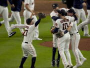 The Houston Astros celebrate their win against the Boston Red Sox in Game 6 of baseball's American League Championship Series Friday, Oct. 22, 2021, in Houston. The Astros won 5-0, to win the ALCS series in game six.