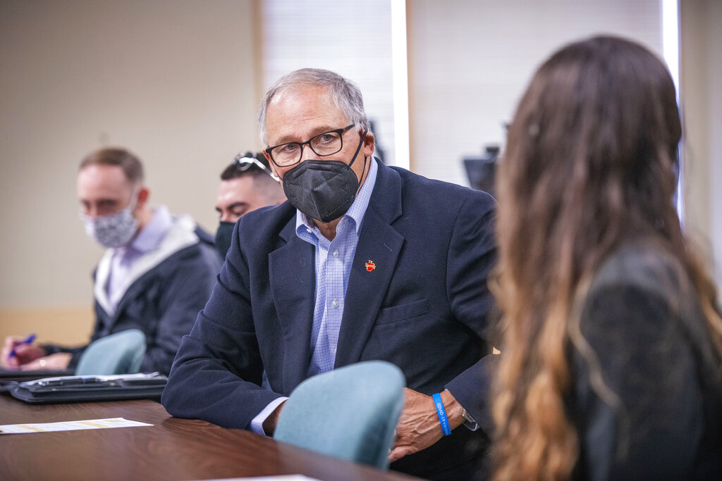 Washington Gov. Jay Inslee talks with student Catalina Garza during his morning visit to Walla Walla Community College in Walla Walla, Wash. Wednesday, Oct. 6, 2021.