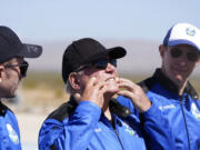 William Shatner, center, describes what the g-forces of the Blue Origin lift off did to his face as Chris Boshuizen, left, and Glen de Vries all look on during a media availability at the spaceport near Van Horn, Texas, Wednesday, Oct. 13, 2021.  The “Star Trek” actor and three fellow passengers hurtled to an altitude of 66.5 miles (107 kilometers) over the West Texas desert in the fully automated capsule, then safely parachuted back to Earth in a flight that lasted just over 10 minutes.