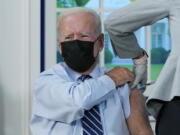 President Joe Biden receives a COVID-19 booster shot during an event in the South Court Auditorium on the White House campus, Monday, Sept. 27, 2021, in Washington.