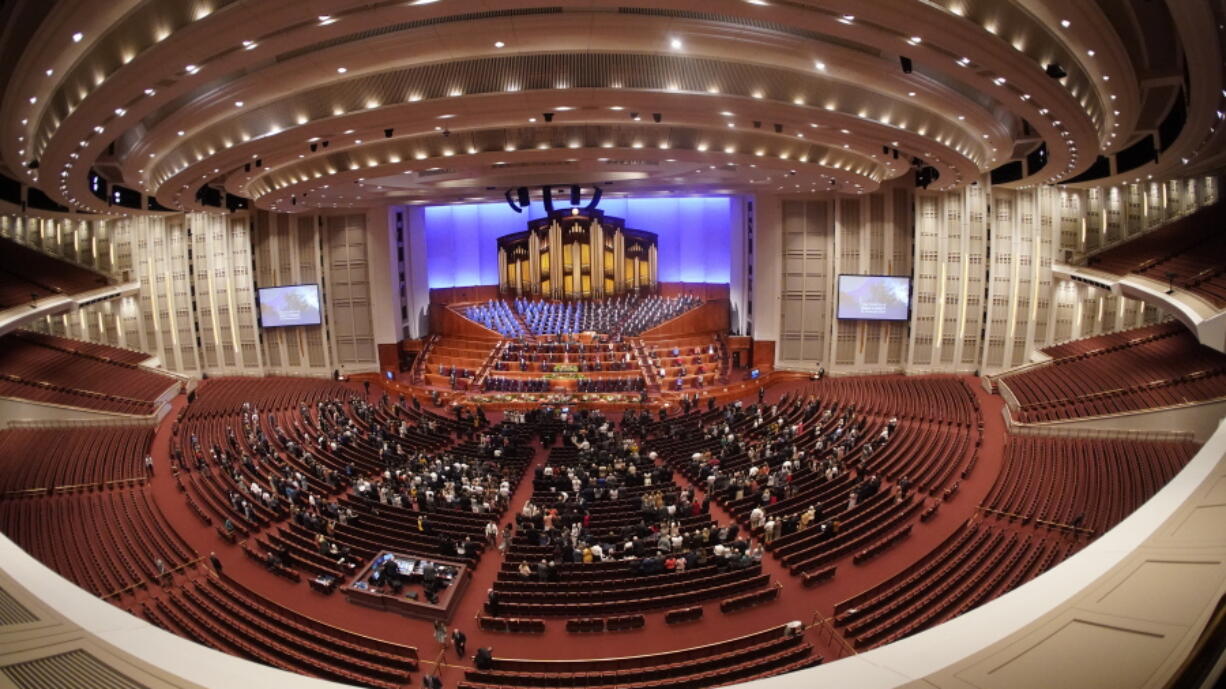 People attend The Church of Jesus Christ of Latter-day Saints' twice-annual church conference Saturday, Oct. 2, 2021, in Salt Lake City. The Utah-based faith has repeatedly encouraged its 16 million members worldwide to limit the spread by getting vaccines and wearing masks. The conference is taking place again without full attendance due to the pandemic. For the first time in two years, though, leaders were back at the faith's 20,000-seat conference center, with several hundred people watching in person.