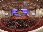 People attend The Church of Jesus Christ of Latter-day Saints' twice-annual church conference Saturday, Oct. 2, 2021, in Salt Lake City. The Utah-based faith has repeatedly encouraged its 16 million members worldwide to limit the spread by getting vaccines and wearing masks. The conference is taking place again without full attendance due to the pandemic. For the first time in two years, though, leaders were back at the faith's 20,000-seat conference center, with several hundred people watching in person.