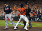 Houston Astros' Jose Siri celebrates past Atlanta Braves starting pitcher Max Fried on a throwing error during the second inning in Game 2 of baseball's World Series between the Houston Astros and the Atlanta Braves Wednesday, Oct. 27, 2021, in Houston.