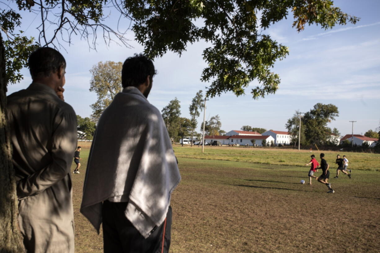 Members of the U.S. military and Afghan refugees play soccer Sept. 30 at the Fort McCoy U.S. Army base in Fort McCoy, Wis. The fort is one of eight military installations across the country that are temporarily housing the tens of thousands of Afghans.