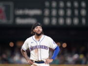 Seattle Mariners' J.P. Crawford stands on the field after being thrown out on a fielder's choice by the Los Angeles Angels to end the sixth inning of a baseball game Sunday, Oct. 3, 2021, in Seattle.