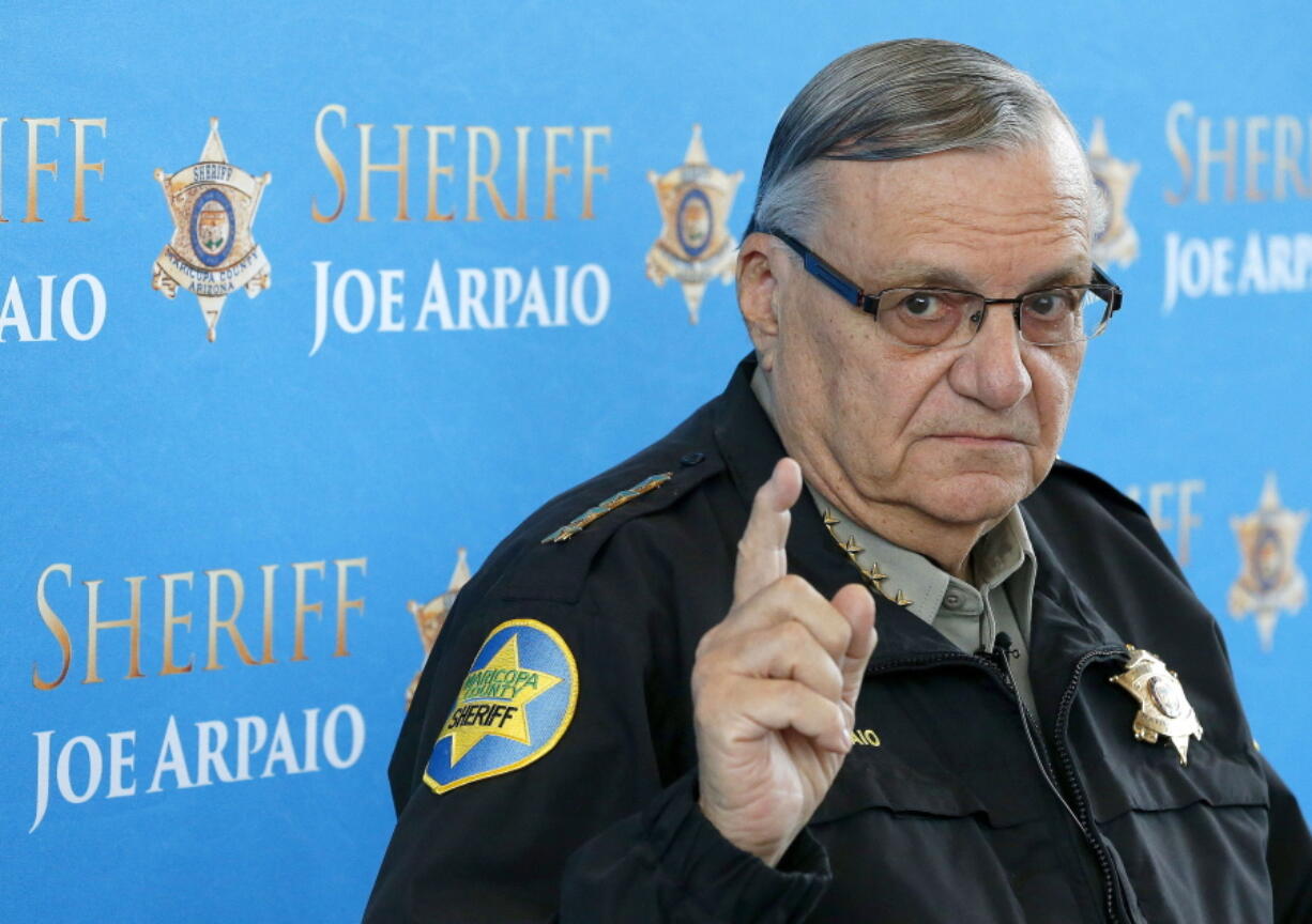 FILE - In this Dec. 18, 2013, file photo, Maricopa County Sheriff Joe Arpaio pauses as he answers a question at a news conference at Maricopa County Sheriff's Office Headquarters in Phoenix. Nearly five years after Arpaio was voted out as sheriff of Arizona's most populous county, taxpayers are covering one of the last major bills from the thousands of lawsuits the lawman's headline-grabbing tactics inspired. (AP Photo/Ross D.