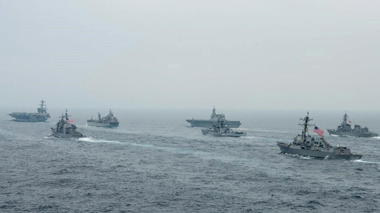 In this photo released by U.S. Navy, US Navy aircraft carrier USS Carl Vinson (CVN 70) and other US and Allies vessels transit the Bay of Bengal as part of MALABAR 2021, on Oct. 12, 2021. China seeks to bring the strategically and symbolically important island back under its control, and the U.S. sees Taiwan in the context of broader challenges from China.