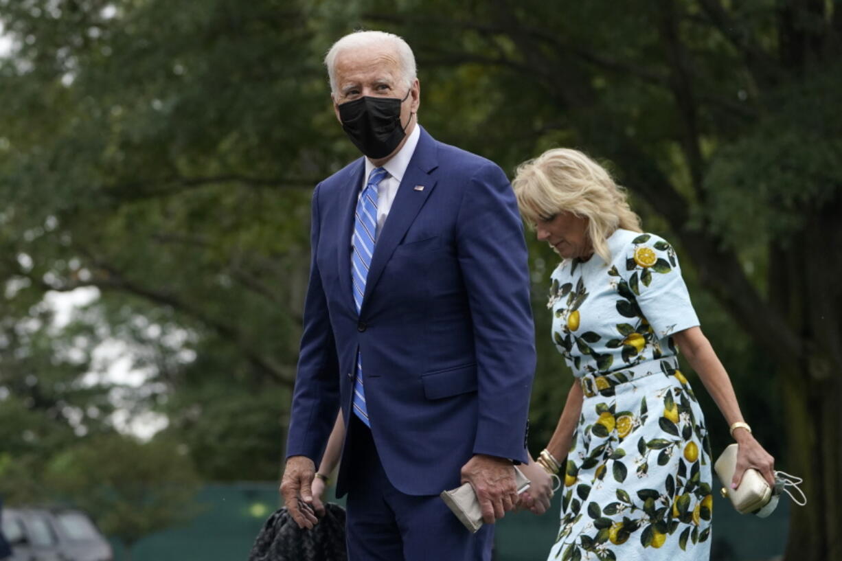 President Joe Biden walks with first lady Jill Biden across the South Lawn of the White House in Washington, Monday, Oct. 11, 2021, after returning on Marine One from a weekend in Wilmington, Delaware.