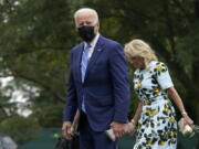 President Joe Biden walks with first lady Jill Biden across the South Lawn of the White House in Washington, Monday, Oct. 11, 2021, after returning on Marine One from a weekend in Wilmington, Delaware.