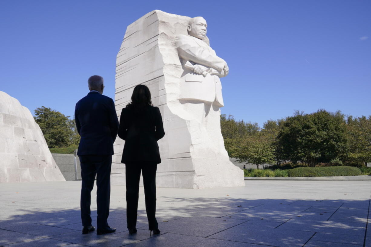 President Joe Biden and Vice President Kamala Harris stand together at the Martin Luther King, Jr. Memorial as they arrive to attend an event marking the 10th anniversary of the dedication of memorial in Washington, Thursday, Oct. 21, 2021.