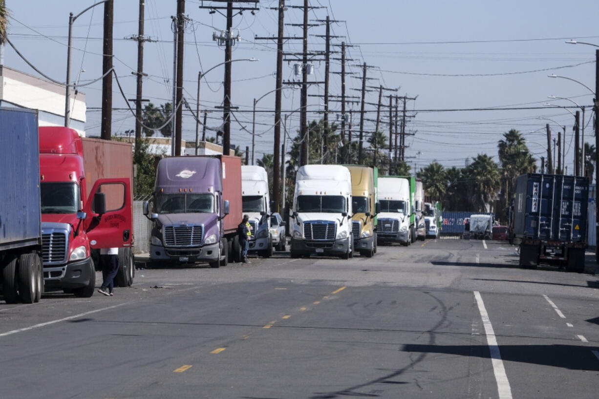 Parked cargo container trucks are seen in a street, Wednesday, Oct. 20, 2021 in Wilmington, Calif. California Gov. Gavin Newsom on Wednesday issued an order that aims to ease bottlenecks at the ports of Los Angeles and Long Beach that have spilled over into neighborhoods where cargo trucks are clogging residential streets. (AP Photo/Ringo H.W. Chiu) (Ringo H.W.