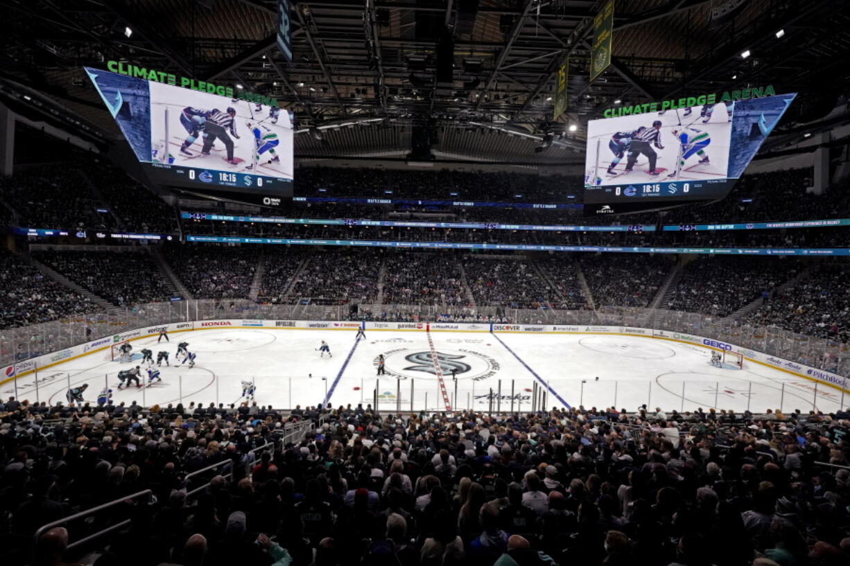 The Seattle Kraken and the Vancouver Canucks play during the first period of an NHL hockey game Saturday, Oct. 23, 2021, in Seattle, in the expansion team's home-opener.