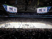 The Seattle Kraken and the Vancouver Canucks play during the first period of an NHL hockey game Saturday, Oct. 23, 2021, in Seattle, in the expansion team's home-opener.