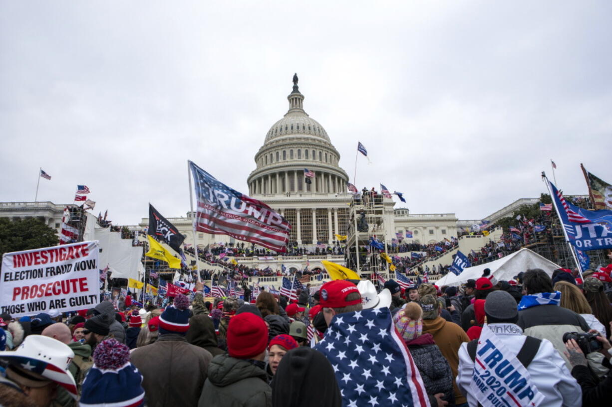 FILE - In this Jan. 6, 2021, file photo insurrections loyal to President Donald Trump rally at the U.S. Capitol in Washington. A federal judge held the director of the District of Columbia's Department of Corrections and the warden of the city's jail in contempt of court on Wednesday, Oct. 13, and asked the Justice Department to investigate whether the civil rights of inmates are being abused. U.S. District Judge Royce Lamberth had hauled the jail officials into court as part of the criminal case into Christopher Worrell, a member of the Proud Boys who has been charged in the Jan. 6 attack at the U.S. Capitol.