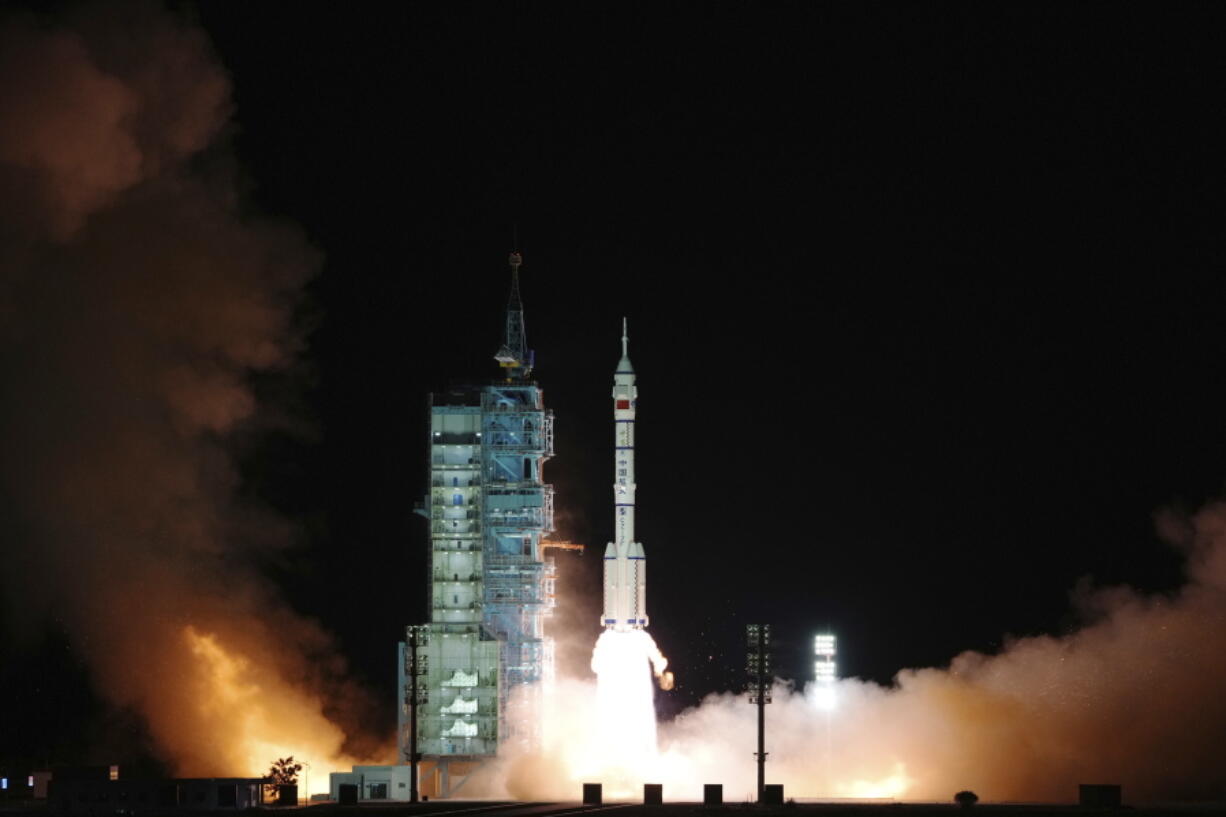 The spaceship Shenzhou-13, atop a Long March-2F carrier rocket, is launched from the Jiuquan Satellite Launch Center today in northwest China's Gobi Desert.