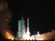 The spaceship Shenzhou-13, atop a Long March-2F carrier rocket, is launched from the Jiuquan Satellite Launch Center today in northwest China's Gobi Desert.