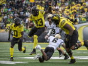 Oregon quarterback Anthony Brown (13) eludes a tackle by Colorado cornerback Mekhi Blackmon (6) during the third quarter of an NCAA college football game Saturday, Oct. 30, 2021, in Eugene, Ore.