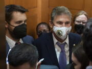 Sen. Joe Manchin, D-W.Va., squeezes into an elevator with White House domestic policy adviser Susan Rice, center, Director of the National Economic Council Brian Deese, left, and other White House officials as they leave a private meeting with Sen. Kyrsten Sinema, D-Ariz., on Capitol Hill in Washington, Thursday, Sept. 30, 2021. Determined not to let his $3.5 trillion government overhaul collapse, President Joe Biden cleared his schedule late Thursday and Speaker Nancy Pelosi pushed the House into an evening session as the Democratic leaders worked to negotiate a scaled-back plan centrist holdouts would accept.