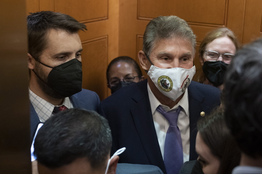 Sen. Joe Manchin, D-W.Va., squeezes into an elevator with White House domestic policy adviser Susan Rice, center, Director of the National Economic Council Brian Deese, left, and other White House officials as they leave a private meeting with Sen. Kyrsten Sinema, D-Ariz., on Capitol Hill in Washington, Thursday, Sept. 30, 2021. Determined not to let his $3.5 trillion government overhaul collapse, President Joe Biden cleared his schedule late Thursday and Speaker Nancy Pelosi pushed the House into an evening session as the Democratic leaders worked to negotiate a scaled-back plan centrist holdouts would accept.