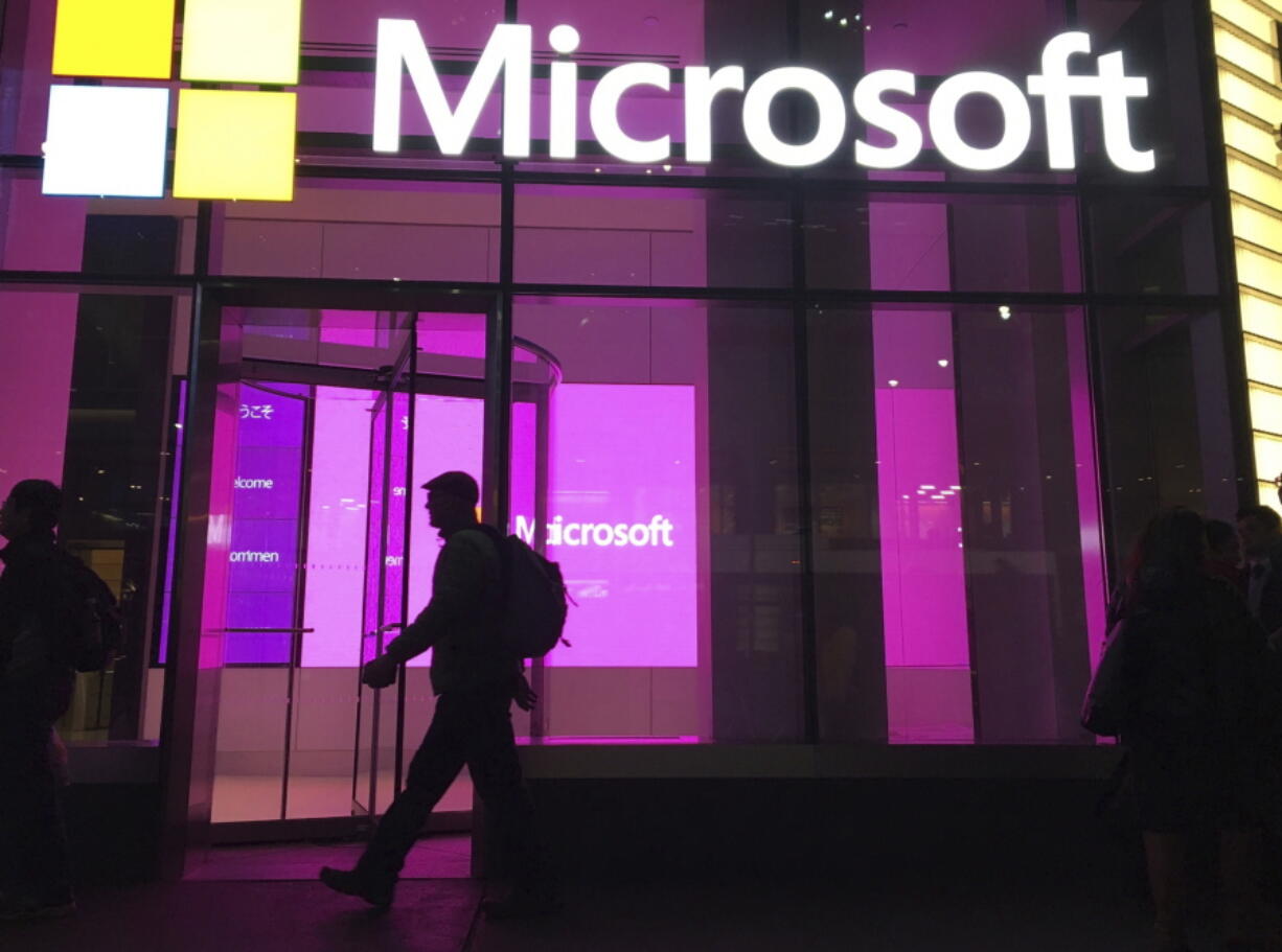 FILE - In this Nov. 10, 2016, file photo, people walk past a Microsoft office in New York. Microsoft on Oct. 7, 2021, says Russia once again accounted for most state-sponsored hacking, with a 58% share of intrusion attempts it detected in the past year. The targets were mostly government agencies -- in the United States, followed by Ukraine, Britain and European NATO members. (AP Photo/Swayne B.