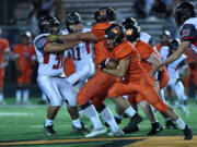 Washougal’s Will Cooper gains yards against R.A. Long on Friday.