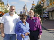 Walt Disney World employees from left, Chuck Milam, Earliene Anderson and Forrest Bahruth gather at the Magic Kingdom on Aug. 30 in Lake Buena Vista, Fla. to celebrate their 50 years working at the park.