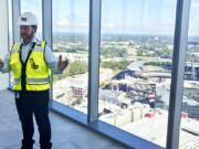 Kevin Lavallee, CEO of TK Elevators' North American operations, stands at the top of the company's new elevator testing facility, Wednesday, Oct. 13, 2021, that towers over the Atlanta Braves stadium and surrounding skyscrapers northwest of Atlanta. The 420-foot-tall tower is set to become fully operational early next year.