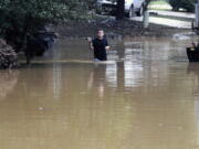 Michael Halbert wades through his flooded neighborhood in Pelham, Ala., on Thursday, Oct. 7, 2021. Parts of Alabama remain under a flash flood watch after a day of high water across the state, with as much as 6 inches of rain covering roads and trapping people.