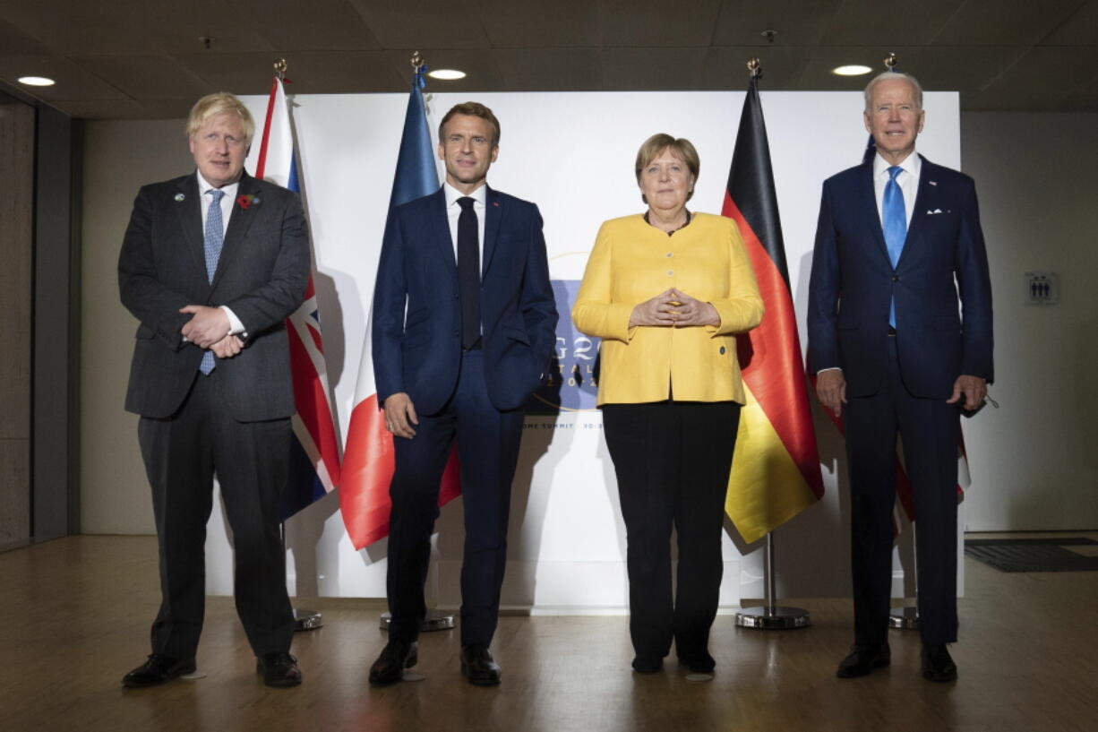 From left, British Prime Minister Boris Johnson, French President Emmanuel Macron, German Chancellor Angela Merkel and U.S. President Joe Biden at the G20 summit in Rome, Saturday, Oct. 30, 2021. The two-day Group of 20 summit is the first in-person gathering of leaders of the world's biggest economies since the COVID-19 pandemic started.