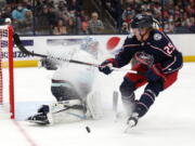 Seattle Kraken goalie Philipp Grubauer, left, stops a shot by Columbus Blue Jackets forward Patrik Laine during the second period of an NHL hockey game in Columbus, Ohio, Saturday, Oct. 16, 2021.