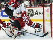 New Jersey Devils goaltender Jonathan Bernier (45) stops a shot by Seattle Kraken's Jordan Eberle (7) during the second period of an NHL hockey game Tuesday, Oct. 19, 2021, in Newark, N.J.